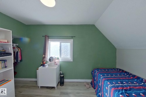 This room features light-toned flooring and a window providing natural light - 9328 106A Avenue, Edmonton, AB - Indoor Photo Showing Bedroom