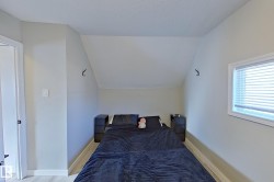 The property features light-colored walls, a window with blinds, and light-colored flooring - 