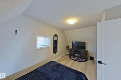 This room features light-colored walls and wood-look flooring, with a window providing natural light - 