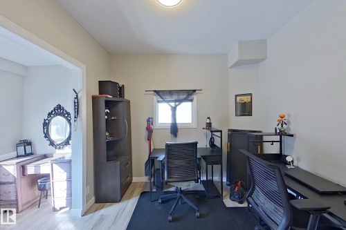 Versatile room featuring light-toned walls, a window with natural light, and light-colored flooring - 9328 106A Avenue, Edmonton, AB - Indoor Photo Showing Office