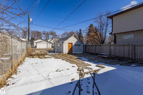 The property includes a detached shed with light grey siding and a wooden door - 9328 106A Avenue, Edmonton, AB - Outdoor