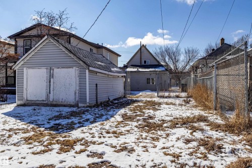 The property features a detached garage with siding and a sloped roof - 9328 106A Avenue, Edmonton, AB - Outdoor