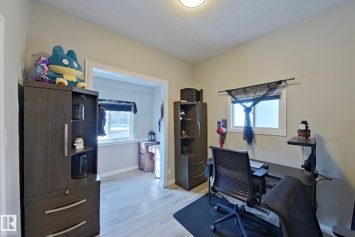 This room features light-colored walls and flooring, with a window providing natural light - 9328 106A Avenue, Edmonton, AB - Indoor Photo Showing Office