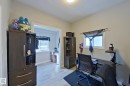 This room features light-colored walls and flooring, with a window providing natural light - 9328 106A Avenue, Edmonton, AB  - Indoor Photo Showing Office 