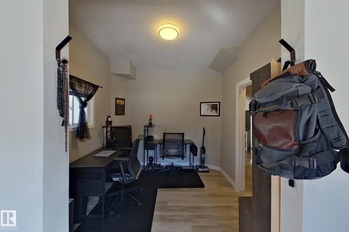 This versatile space features a window, light-colored walls, and a ceiling light fixture - 9328 106A Avenue, Edmonton, AB - Indoor