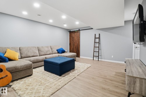 This living space features light-colored walls, recessed lighting, and light-toned flooring - 430 Watt Boulevard, Edmonton, AB - Indoor