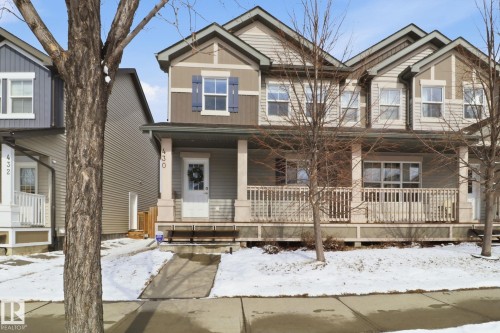 The property presents an inviting facade with a covered front porch featuring white railing - 430 Watt Boulevard, Edmonton, AB - Outdoor With Deck Patio Veranda With Facade