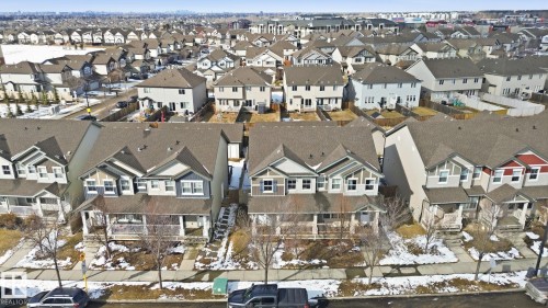 Aerial view showcasing multiple properties within a residential area, featuring houses with gabled roofs and distinct exterior finishes - 430 Watt Boulevard, Edmonton, AB - Other