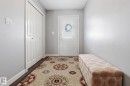 Inviting entryway featuring a white paneled door with decorative glass, a coat closet with bi-fold doors, and light gray painted walls - 430 Watt Boulevard, Edmonton, AB  - Indoor 