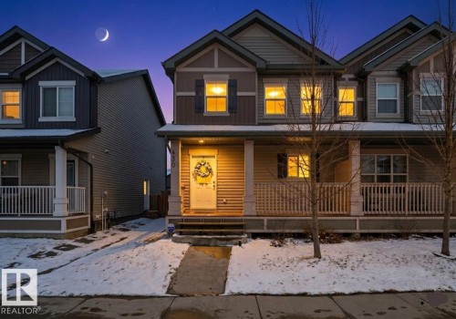 The property features a charming front porch, exterior siding, and multiple windows - 430 Watt Boulevard, Edmonton, AB - Outdoor With Deck Patio Veranda With Facade