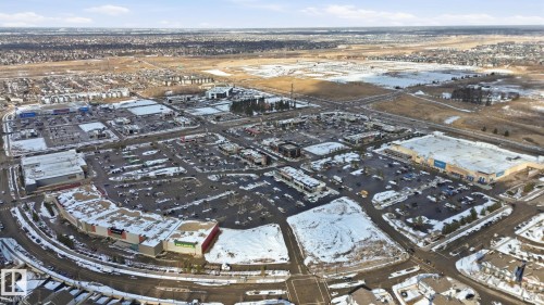 Aerial view of the surrounding area featuring commercial buildings, parking lots, and undeveloped land - 430 Watt Boulevard, Edmonton, AB - Outdoor With View