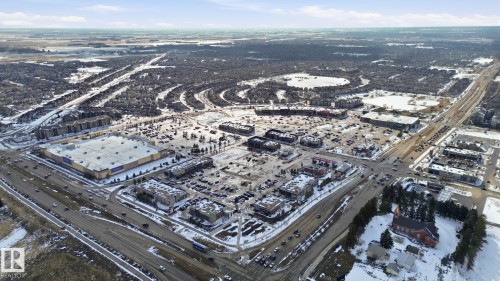 Aerial view showcasing the property's location within a developed area featuring commercial buildings, residential areas, and roadways - 430 Watt Boulevard, Edmonton, AB - Outdoor With View