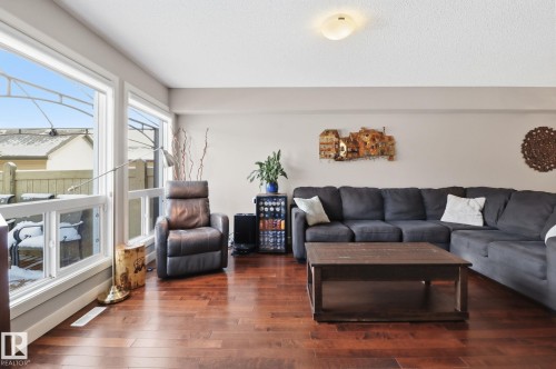 Living area featuring hardwood flooring, large windows, and light-colored walls - 430 Watt Boulevard, Edmonton, AB - Indoor Photo Showing Living Room
