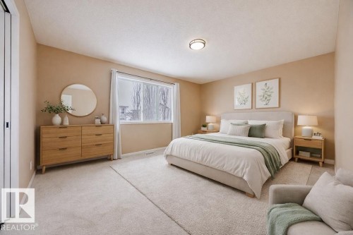 This bedroom features soft neutral tones, plush carpeting, and a large window providing natural light - 7 Doucette Place, St. Albert, AB - Indoor Photo Showing Bedroom