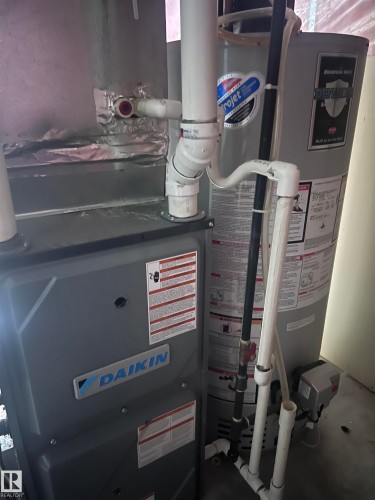This property includes a Daikin brand heating and air conditioning unit and a Bradford White water heater, both featuring visible piping - 7 Doucette Place, St. Albert, AB - Indoor Photo Showing Basement
