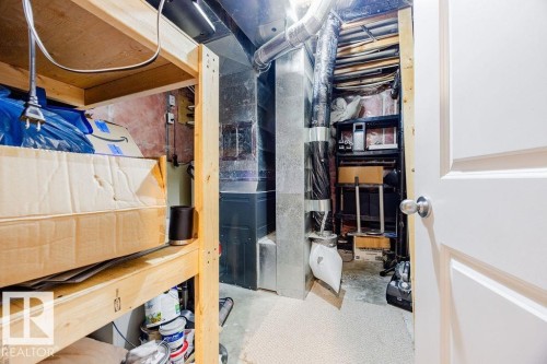 Utility area featuring exposed ductwork and a white paneled door - 7 Doucette Place, St. Albert, AB - Indoor