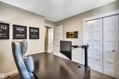 The room features light-colored walls and a textured carpeted floor - 5201 40 Avenue, Beaumont, AB - Indoor