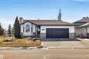 This property features a single-story design with a two-car garage, a paved driveway, and a front yard - 5201 40 Avenue, Beaumont, AB  - Outdoor 