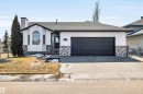 The property features a white exterior with dark gray accents and a two-car garage - 5201 40 Avenue, Beaumont, AB  - Outdoor 