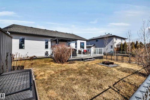 The property features a large yard with a deck, a fire pit, and a shed - 5201 40 Avenue, Beaumont, AB - Outdoor With Deck Patio Veranda With Exterior