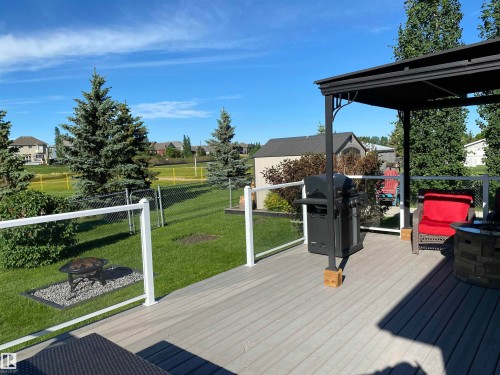 Spacious outdoor deck featuring a dark gazebo, a barbecue grill, and a fire pit - 5201 40 Avenue, Beaumont, AB - Outdoor With Deck Patio Veranda