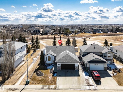 Aerial view of the property featuring a two-car garage, a paved driveway, and a front yard with landscaping - 5201 40 Avenue, Beaumont, AB - Outdoor With View