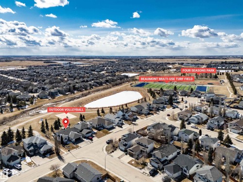 Aerial view of the neighborhood showcasing nearby amenities including an outdoor volleyball court, a multi-use turf field, and a park - 5201 40 Avenue, Beaumont, AB - Outdoor With View