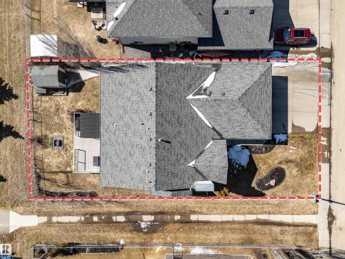Aerial view of the property showcasing the roof, driveway, deck, and a shed - 5201 40 Avenue, Beaumont, AB - Outdoor