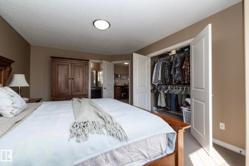 Bedroom with carpeted flooring, a ceiling-mounted light fixture, and a closet with bifold doors - 130 Kirpatrick Way, Leduc, AB - Indoor Photo Showing Bedroom