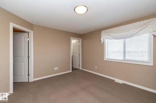 Room featuring carpeted flooring and a window with blinds and a decorative valance - 130 Kirpatrick Way, Leduc, AB - Indoor Photo Showing Other Room