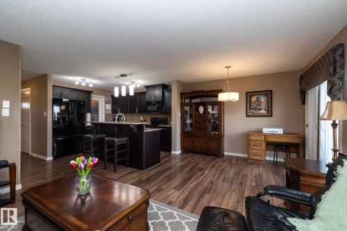 Open concept living area featuring dark wood-style flooring throughout - 130 Kirpatrick Way, Leduc, AB - Indoor