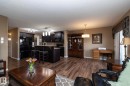 Open concept living area featuring dark wood-style flooring throughout - 130 Kirpatrick Way, Leduc, AB  - Indoor 