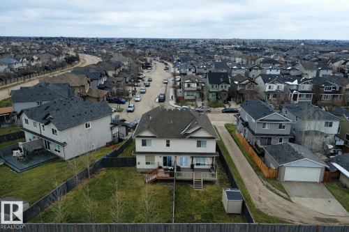 The property is located within a residential neighborhood featuring paved streets and sidewalks, with a variety of detached homes visible - 130 Kirpatrick Way, Leduc, AB - Outdoor With View