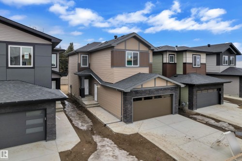 The property features a two-story design with a brown facade and dark stone accents - 237 Linden Loop, Leduc, AB - Outdoor
