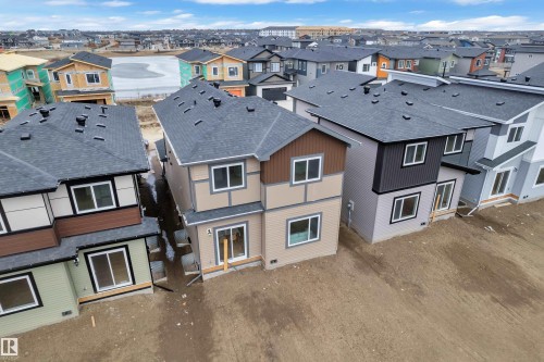 The property features a multi-story exterior with a shingled roof, offering a modern aesthetic - 237 Linden Loop, Leduc, AB - Outdoor