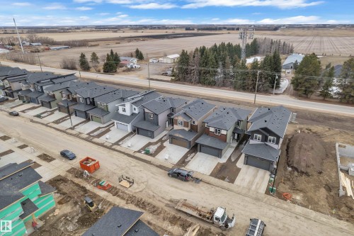 The property is part of a newly developed street featuring modern homes with dark roofs and light-colored siding - 237 Linden Loop, Leduc, AB - Outdoor With View