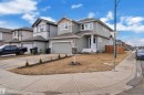 The property features light gray siding, a prominent front entrance with white steps, and an attached garage - 1452 30 Street, Edmonton, AB  - Outdoor With Facade 