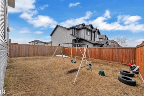The property features a fenced backyard with a swing set - 1452 30 Street, Edmonton, AB - Outdoor