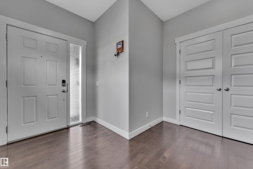 Entryway featuring hardwood floors, a white paneled door with a sidelight, and white trim - 1452 30 Street, Edmonton, AB - Indoor Photo Showing Other Room