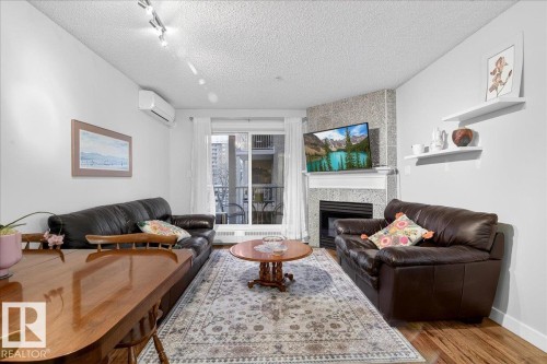 307 11716 100 Avenue, Edmonton, AB - Indoor Photo Showing Living Room With Fireplace