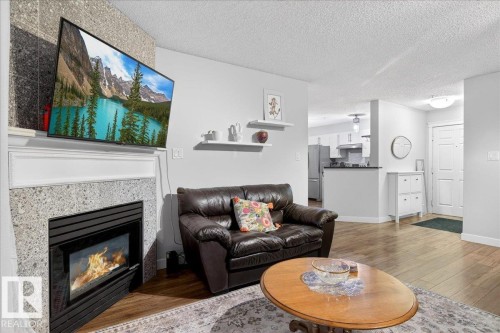 307 11716 100 Avenue, Edmonton, AB - Indoor Photo Showing Living Room With Fireplace