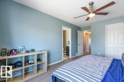 This room features a ceiling fan with light, light blue walls, and carpeted flooring - 3119 Carpenter Landing Landing, Edmonton, AB - Indoor Photo Showing Bedroom