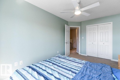 Bedroom with light blue walls, carpeted flooring, and a ceiling fan with integrated lighting - 3119 Carpenter Landing Landing, Edmonton, AB - Indoor Photo Showing Bedroom