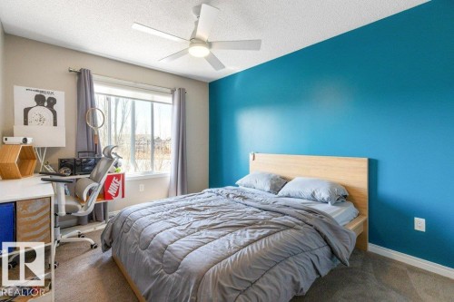 This room features a window providing natural light, a ceiling fan, and carpeting - 3119 Carpenter Landing Landing, Edmonton, AB - Indoor Photo Showing Bedroom