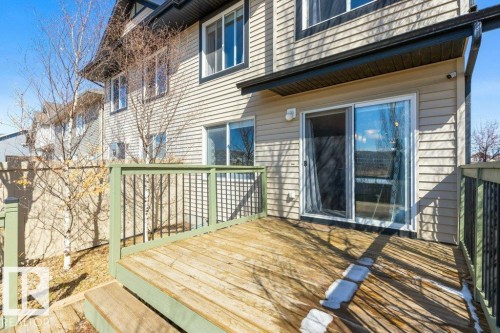 The property features an outdoor deck with wooden flooring and a green railing - 3119 Carpenter Landing Landing, Edmonton, AB - Outdoor With Deck Patio Veranda