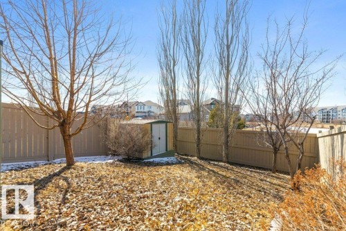 The property features a fenced yard with a storage shed and mature trees - 3119 Carpenter Landing Landing, Edmonton, AB - Outdoor