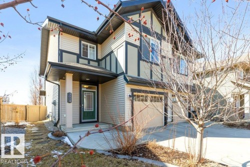 The property features a two-story exterior with light-colored siding and dark trim accents - 3119 Carpenter Landing Landing, Edmonton, AB - Outdoor