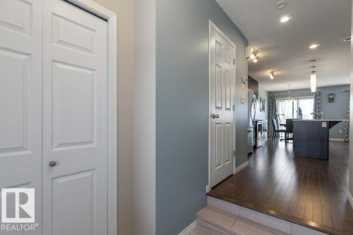 This property features rich hardwood flooring, recessed lighting, and a modern kitchen with an island - 3119 Carpenter Landing Landing, Edmonton, AB - Indoor Photo Showing Other Room