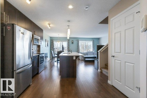 The main living area features durable hardwood flooring throughout - 3119 Carpenter Landing Landing, Edmonton, AB - Indoor Photo Showing Kitchen With Stainless Steel Kitchen