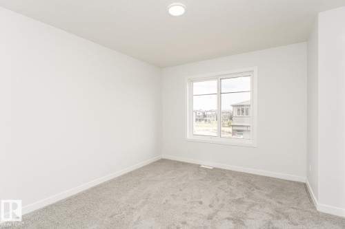 This room features light grey carpeting, white walls, and a recessed ceiling light fixture - 6371 King Wynd, Edmonton, AB - Indoor Photo Showing Other Room